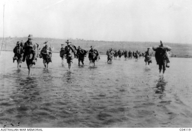 Lemnos, Greece. October 1915. 1st Section and 2nd Section of 1st Field Company Engineers arriving from Anzac for a spell crossing the shallow arm of Mudros Harbour towards Sarpi Camp. In this way a march of about two miles was saved. Left to right: Spr 108 Walter Stallard, Corporal 66 Norman Masters, Spr 14 Edmond Banks; unidentified; Spr Cole; Spr 176 William Harvey; unidentified; Spr Pat Murray; Spr Roberts; unidentified. (Donor E. G. Lloyd) AWM C04119