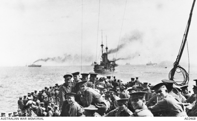 AWM A02468 -Troops of the 11th Battalion and 1st Field Company Australian Engineers assembled on the forecastle of HMS London, part of the fleet which carried the Australians from Lemnos for the Gallipoli landing at Anzac Cove. HMS Bacchante is steaming ahead. Photo taken by Ashmead-Bartlett, Ellis