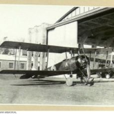 An Avro 504K aircraft, Serial F9749, of No 7 (Training) Squadron, Australian Flying Corps (AFC), outside hangars at Leighterton aerodrome, England. An 'A' is painted under the front cockpit.